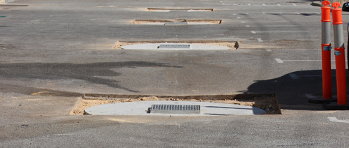 A line of newly installed soakwell covers