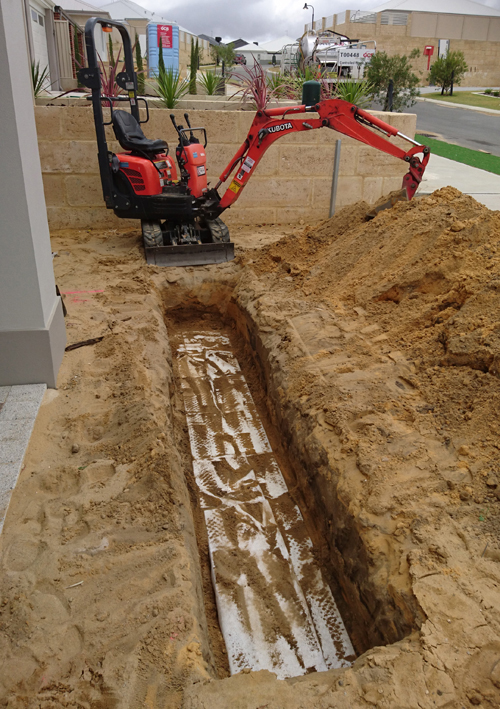 Our mini excavator pictured with some installed modular soakwells.