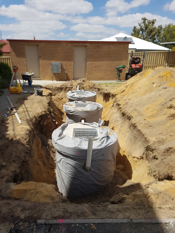 Three concrete soakwells installed in a Perth apartment block.